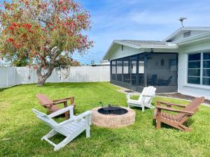 two chairs and a fire pit in a yard at 5 min drive to Beach - Beach Gear, Bikes, Firepit in Englewood