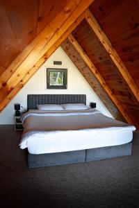 a bedroom with a large bed in a attic at Woodhouse in Bijelo Polje