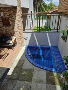 a swimming pool with blue tiles on a patio at Flêbeach in Flecheiras