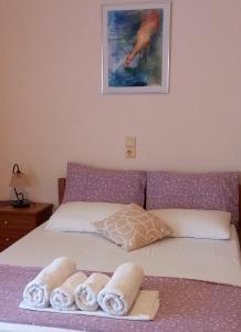 un letto con asciugamani in una camera da letto di Maridatis Apartments a Paleocastro (Palekastron)