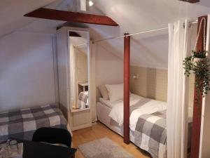 a small bedroom with two beds in a room at Kopparstugans Bed & Breakfast in Falun