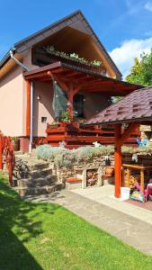 a house with a wooden structure with a garden at Privát JOZEF in Vrbov