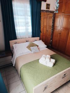 a bedroom with a bed with two towels on it at Angelic House in Spetses