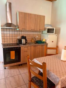 a kitchen with a table and a stove top oven at Rustic in Mediaş