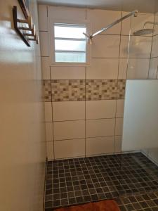a bathroom with a shower with a window at CHEZ TI KARL in Le Tampon +12 photos