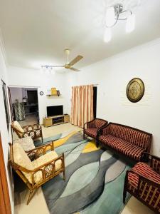 a living room with couches and a large rug at ANGGUN HOMESTAY Banting in Banting