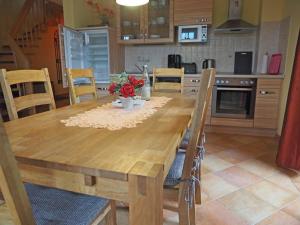 a wooden table and chairs in a kitchen at Ferienhaus Mandy in Wohlenberg