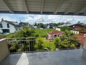 a balcony with a view of a yard with houses at Sunshine FeWo in Rust