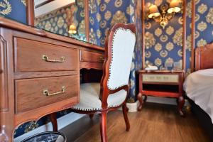 a bedroom with a desk with a chair and a dresser at T Hotel in Taichung