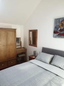 a bedroom with a bed and a dresser and a mirror at Lanarth Chalet in Hayle Cornwall in Hayle