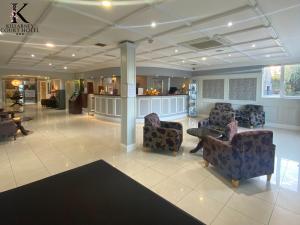 a lobby with couches and chairs and a bar at Killarney Court Hotel in Killarney