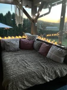 a couch sitting in front of a large window at Glamping Karavan in Chrášťany