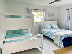 a bedroom with two bunk beds and a window at 5 min drive to Beach - Beach Gear, Bikes, Firepit in Englewood