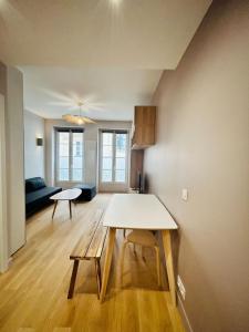 a living room with a table and a couch at New studio fully furnished - Rue d'Enghien, Paris in Paris