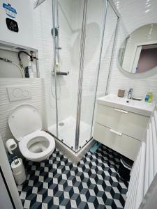 a bathroom with a shower and a toilet and a sink at New studio fully furnished - Rue d'Enghien, Paris in Paris