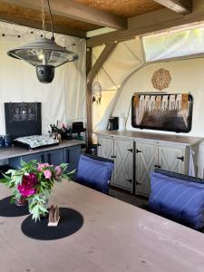 a tent with a table and chairs and a television at Glamping Karavan in Chrášťany