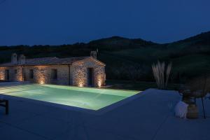 a villa with a swimming pool at night at B&B Panfilo Farmhouse in Cellino Attanasio