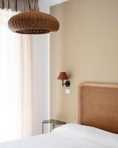 a bedroom with a bed and a window with a lamp at Hotel Piccolo Mondo in Lido di Camaiore