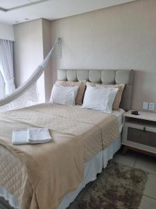 a bedroom with a large bed and a window at Terraço do Atlântico in Fortaleza