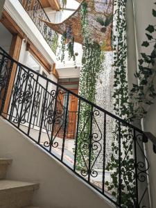 un escalier avec balustrade en fer forgé et lierre dans l'établissement Appartement Saint Jean 2 Cosy et Confort, à Villefranche-de-Conflent