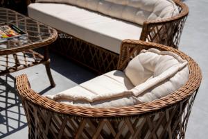 a wicker chair sitting next to a bed at My Hotel in Antalya