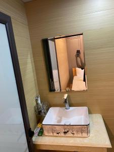 a bathroom with a sink and a mirror at Jewel Homestay in Hai Phong