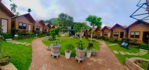 a courtyard with a bunch of houses and potted plants at Jewel Homestay in Hai Phong