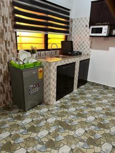 a kitchen with a sink and a counter top at Nyawoyi villa in Tokuse +5 photos