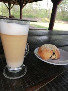 a drink and a donut sitting on a table at Gospodarstwo Agroturystyczne Zacisze in Ruś