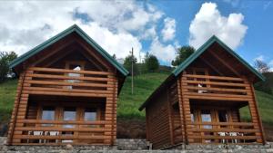 a log cabin with two windows in a field at Cottages Jasavić in Plav