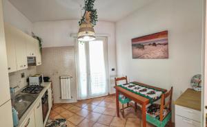 a kitchen with a table and a table and a dining room at Villa DolceVita in Fregene