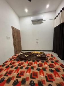 a room with a bed and a heater on the wall at Rukmani Rooms in Mathura