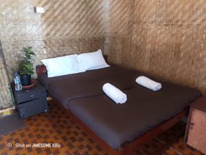 a bed in a room with two pillows on it at This is it Beachfront - Rooms, Cafe & Events in Arambol
