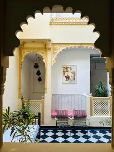 two benches in a room with a checkered floor at Hotel Mewari Villa PURE VEG in Udaipur