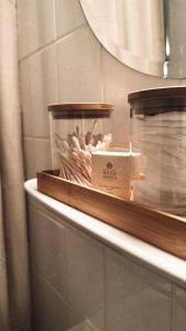 a shelf in a bathroom with a mirror and a box at Lille hygge in Leck