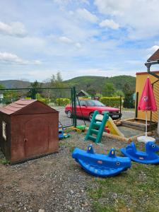 a playground with a slide and a play set at Na Mýtince in Moraň