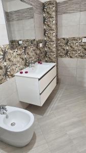 a bathroom with a sink and a toilet and a mirror at MauriCarol Residences in Acquarica del Capo +108 photos