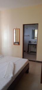 a bedroom with a bed with a mirror and a sink at Picho two bedroom apartment in Malindi