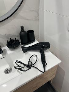 a black hair dryer sitting on top of a sink at Casa Alma in Montoro