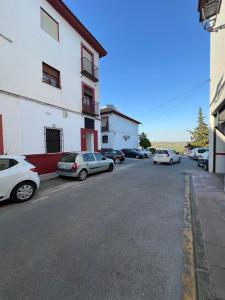 a parking lot with cars parked in front of a building at Casa Alma in Montoro