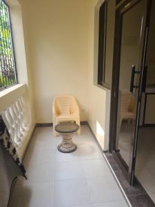 a bathroom with a toilet in the corner of a room at Picho two bedroom apartment in Malindi