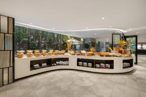 a store with a counter filled with bowls of food at Satya Da Nang Hotel Han Market in Danang