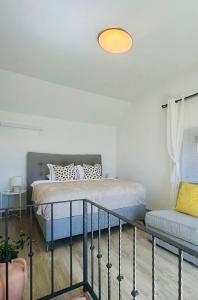 a bedroom with a bed and a couch at Casa natura - Olib, gem of islands in Olib