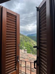 an open door to a balcony with a view at MAJELLA Pacentro in Pacentro