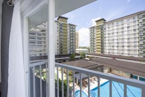 a balcony with a view of the pool and buildings at Studio Unit Near SM City and Ayala with Pool, Gym, Balcony and Fast Wifi in Mandaue City