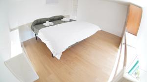 a small white bedroom with a bed and a mirror at LUNELLA HOME FULL APARTMENT with UNIQUE SEAVIEW, WASHING MACHINE, FULL KITCHEN, PARKING with VIDEO SURVEILLANCE, and SHUTTLE TAXI from to CENTRAL STATION, AMALFI FERRIES, SALERNO AIRPORT, NAPLES AIRPORT in Salerno +111 photos