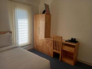 מיטה או מיטות בחדר ב-Windfall Service Apartment