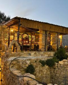 a stone house with a stone wall at Dana Tower Hotel in Dana