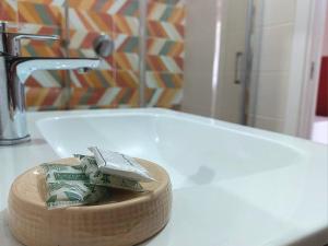 a bathroom with a sink with a roll of money at Casa sulla Punta in Marina di Camerota