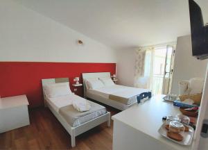 a small room with two beds and a table at Casa sulla Punta in Marina di Camerota